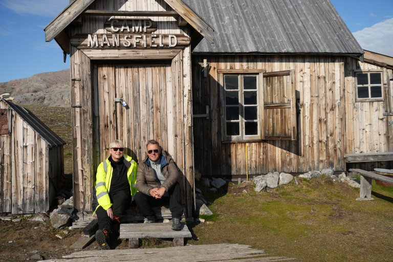 Researchers Anne-Cathrine Flyen and Atle Wehn Hegnes in the abandoned mining town of London on Blomstrandhalvøya in Kongsfjorden, Svalbard, where tourists were interviewed and observed in the field. Although the cabin behind them is protected as cultural heritage, it is still being used, and is therefore maintained in good condition. Photo: Anne-Cathrine Flyen / Norwegian Institute for Cultural Heritage Research