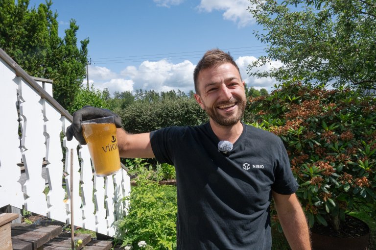 Det kan hjelpe å tisse litt på hageavfallskomposten, tipser forsker Pierre-Rivier Adrien, i NIBIO, her med urin i halvliters-glass. Urin er også veldig nyttig å gjødsle plantene med, da tynnet ut med vann – bruk en halvliter i en 10 liters vannkanne. Det holder å gjøre dette mellom 2-6 ganger per sesong, avhengig av næringsbehovet til plantene. Stopp gjødsling med urin 2-3 uker før høsting. Foto Anette Tjomsland Spilling